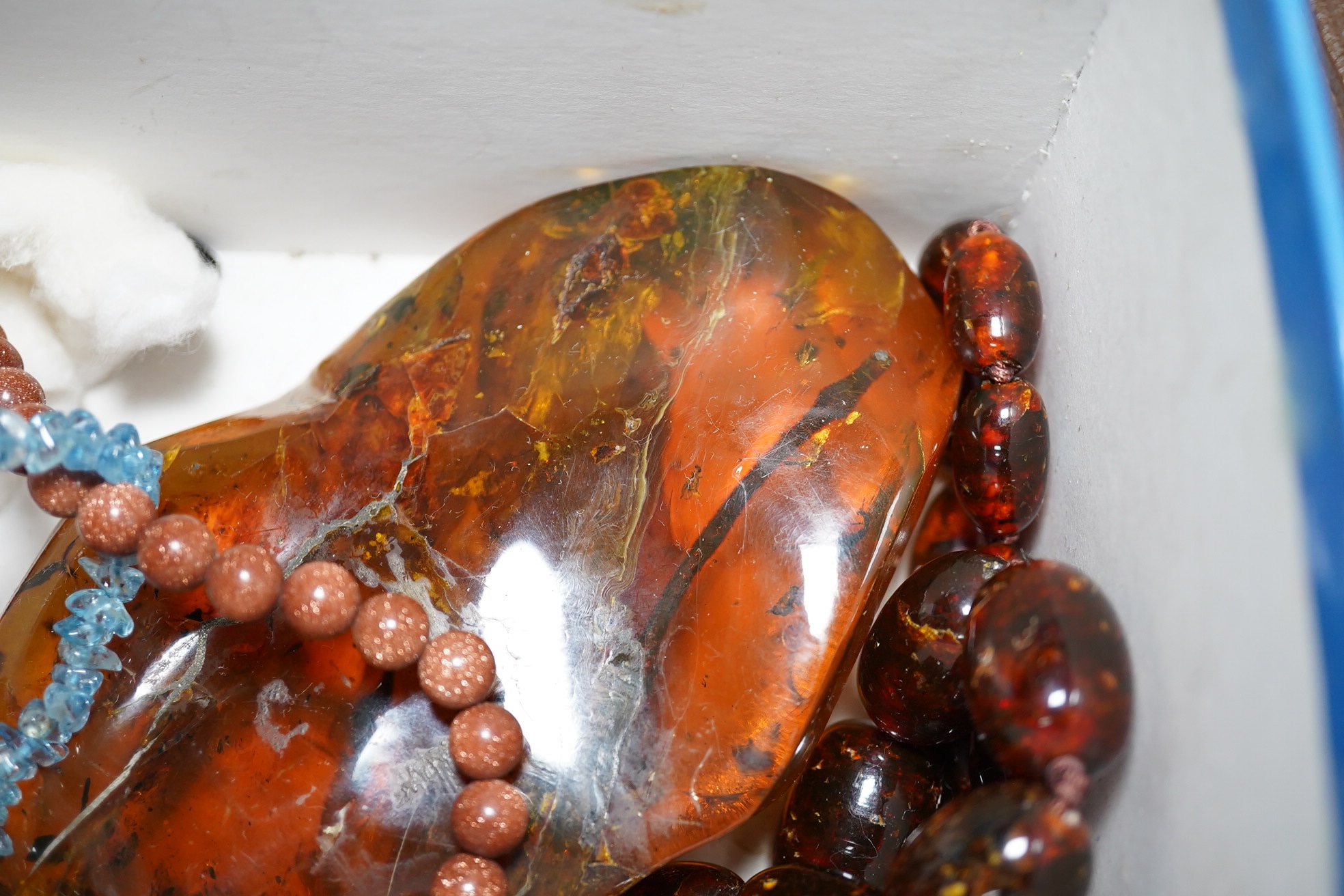 A group of assorted amber and other jewellery including carnelian necklace, glass bead necklace, aquamarine pebble necklace, etc. Condition - fair